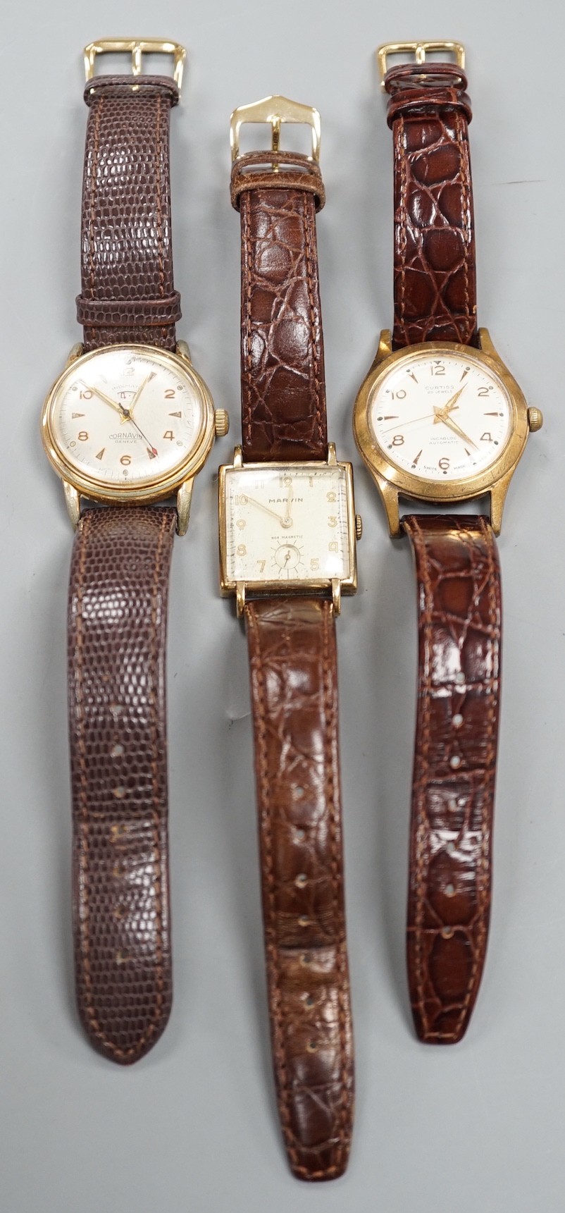 A gentleman's 1940's 9ct gold Marvin square dial manual wind wrist watch, on a later leather strap, together with two other gentleman's steel and gold plated wrist watches, Cornavin and Curtiss automatic.